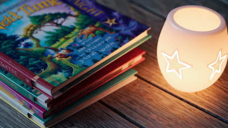 stack of children's books with a nightlight