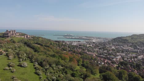 left to right pan of dover cast, dover town and the ferry terminal on a suny day in southeast england