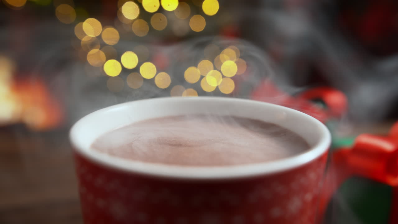 Dipping A Gingerbread Man Biscuit In A Cup Of Hot Steaming Chocolate On Christmas Eve by the Fireplace