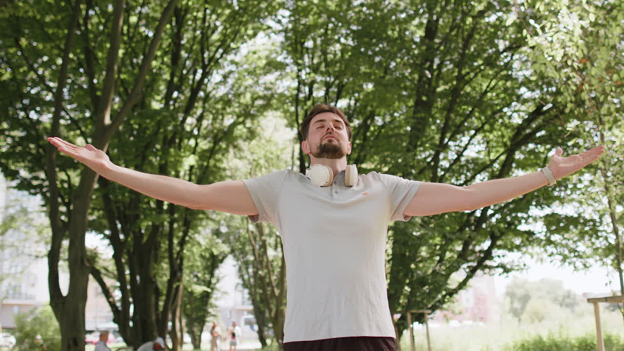 Man jogger meditating breathes deeply with mudra gesture praying eyes closed keep calm down relax