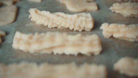 fresh raw cookie dough lies on a baking sheet ready for the oven