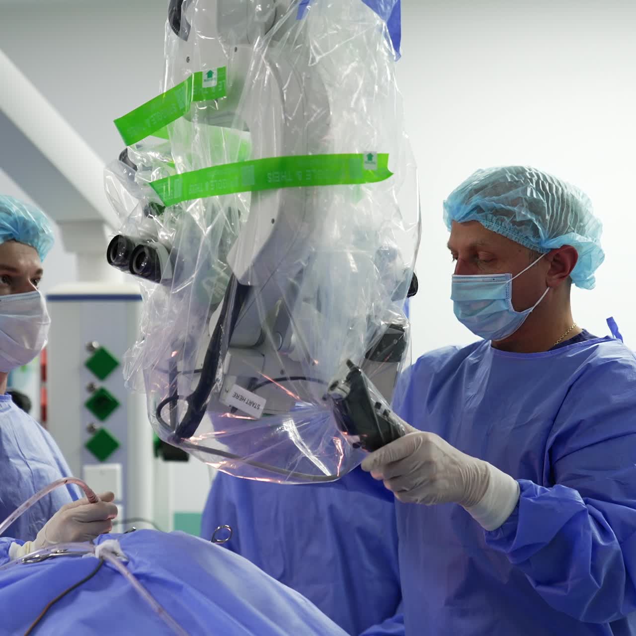 Professional surgeon moving forward the microscope up to the patient. Specialist adjusting the precise technological equipment over the operated patient