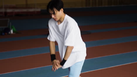 Young-man-stretching-indoors