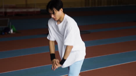 young man stretching indoors