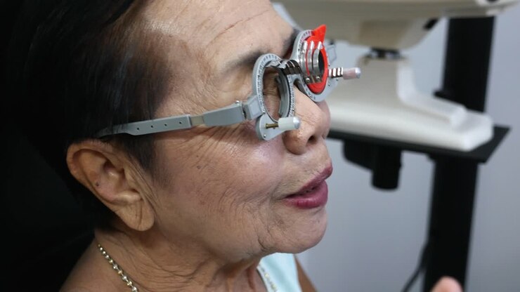 Using a trial frame, elderly is having her eyes checked manually in an optical shop in Bangkok, Thailand