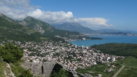 Seaside-town-by-the-mountains-from-above,-Southern-Europe,-reveal-shot