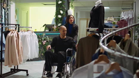 person in wheelchair shopping in a fashion store