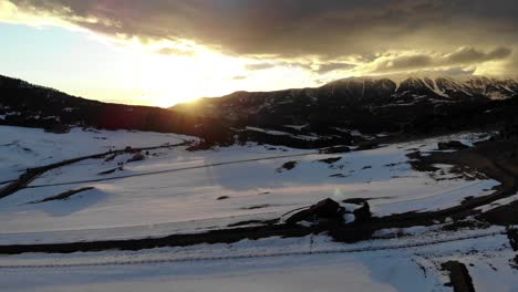 drone shot of an amazing sunset behind the mountains during winter