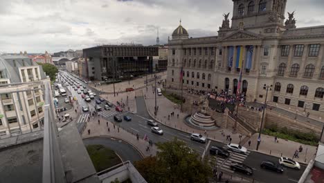 activists protesting on stairs of prague national museum, wide shot