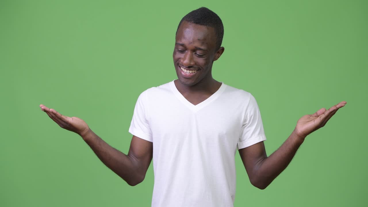Young African man smiling while choosing between left and right