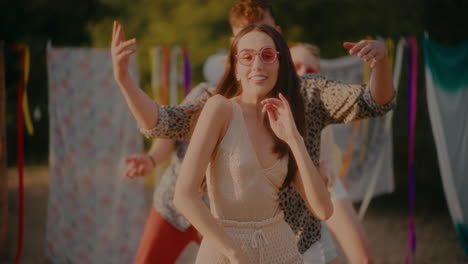 happy women and men swaying sideways while enjoying at beach