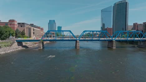 blue bridge over grand river in downtown grand rapids, michigan with drone video moving left to right