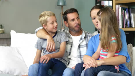 cute family talking sitting on the couch