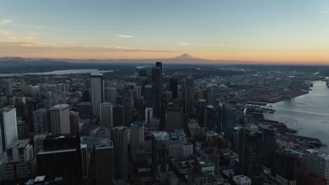 scenic view of downtown district and seattle waterfront with orange horizon and mt rainer