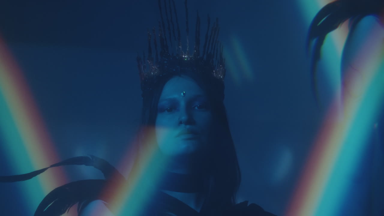 Woman in Gothic Crown and Feather Outfit