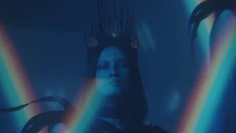 woman in gothic crown and feather outfit