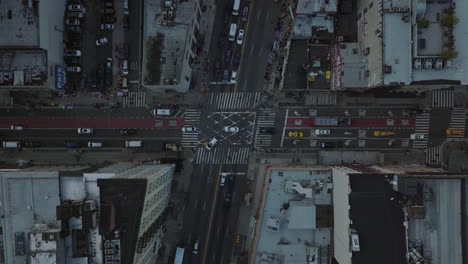 Aerial-birds-eye-overhead-top-down-ascending-footage-of-vehicles-passing-through-road-intersection-in-city.-Manhattan,-New-York-City,-USA