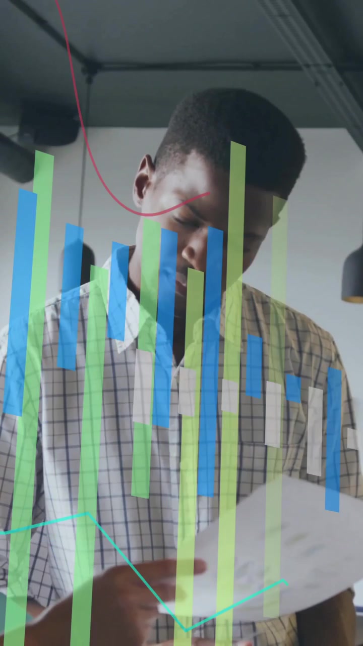 Reviewing documents, business colleagues analyzing data visualization overlay in office setting