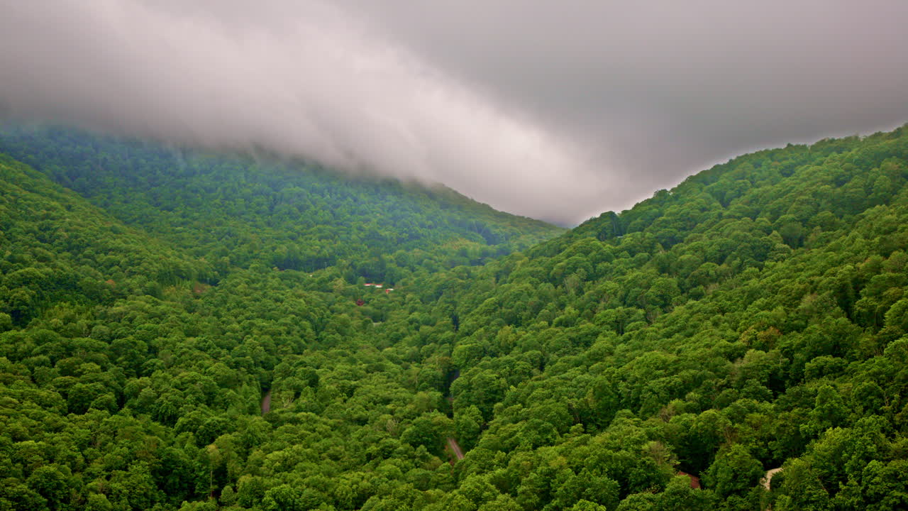 Cinematic drone footage reveals fog-drenched Smoky ridges