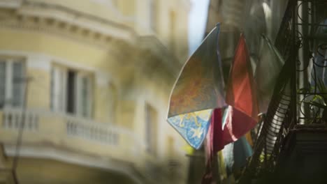 day shot close up of typical balcony at havana cuba with colorful clothes hanging waving in the wind yellow building at background fresh clean feeling sunny day