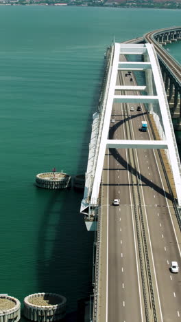 aerial view of a modern arch bridge over a waterway