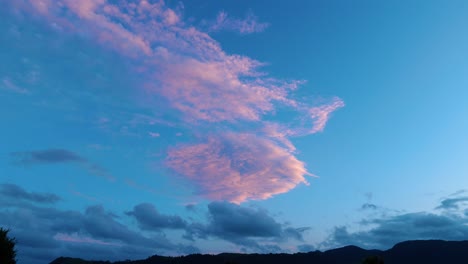 purple haze: stunning stock footage of a lone cloud painted in shades of purple during a mesmerizing sunset