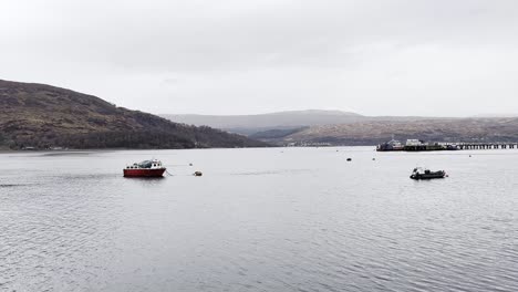 Fishing-boats-anchored-in-Loch-Eil,-Fort-William-on-a-cloudy-spring-day