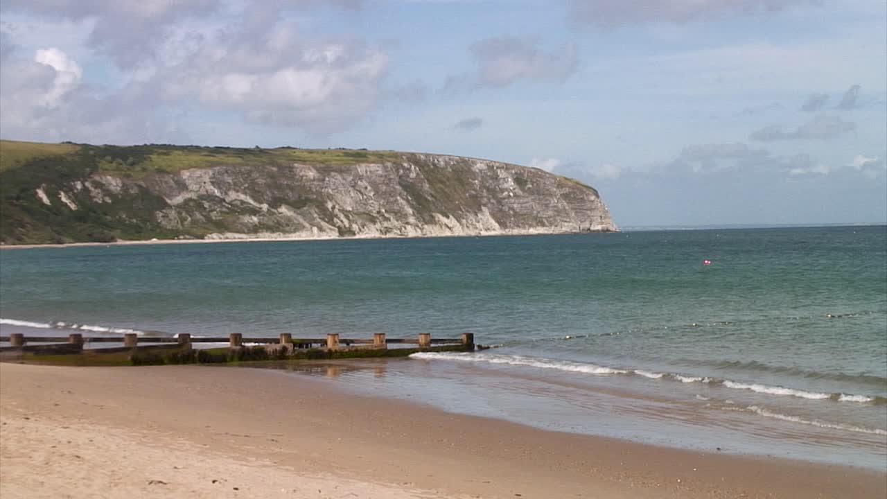 Sandy beach and white cliffs at Swanage Bay in the coastal town of Swanage in the county of Dorset in England