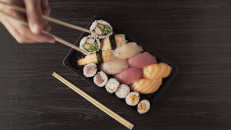 delivery food concept: opening sushi from plastic tableware. top view
