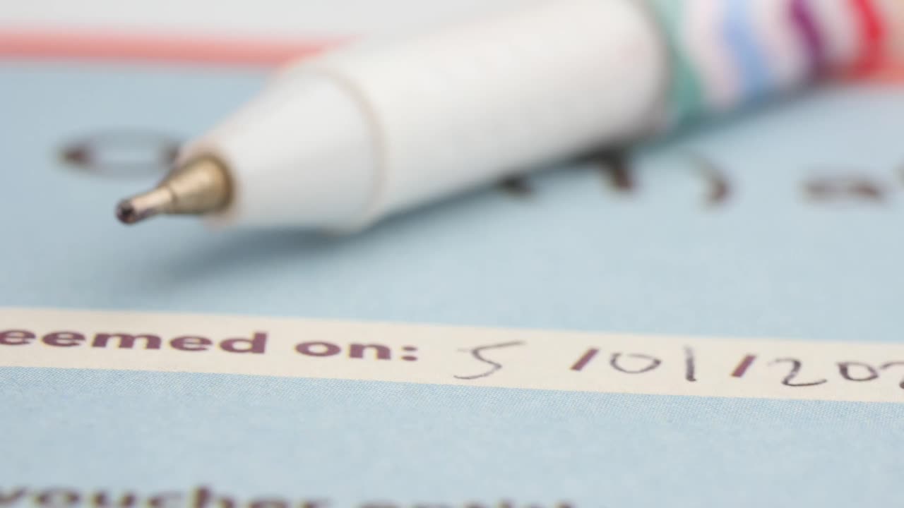 Close-up of a pen on a redeemed voucher
