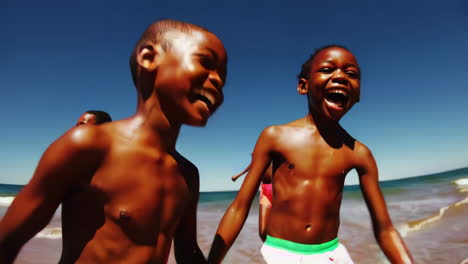 happy children running and playing on a sunny beach