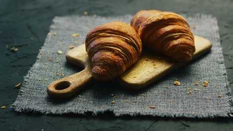 fresh croissants on chopping board