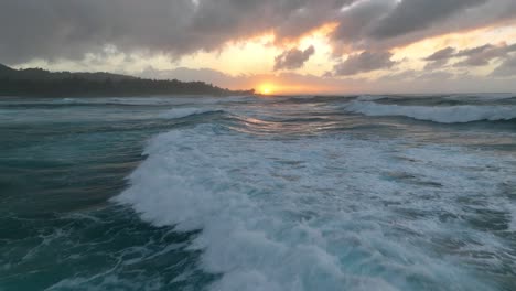 aerial sunset view of big ocean waves breaking in hawaii