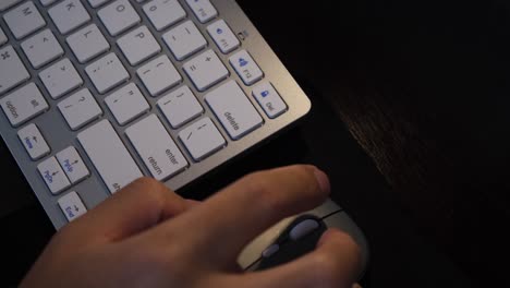 hand working on desk with wireless computer mouse and keyboard