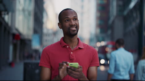 Slow-Motion-Portrait-of-happy-african-american-man-using-smart-phone