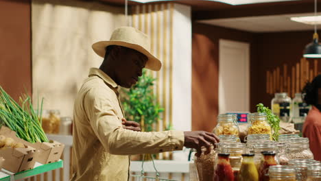 african american client shopping for pasta or grains in jars