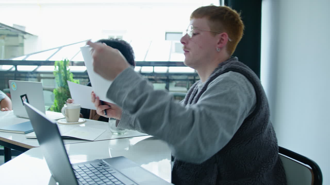 Young Colleagues Discussing Papers on Business Meeting