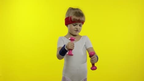 Caucasian-girl-in-sportswear-making-exercises-with-dumbbells.-Workout-for-kids.-Athletic-child