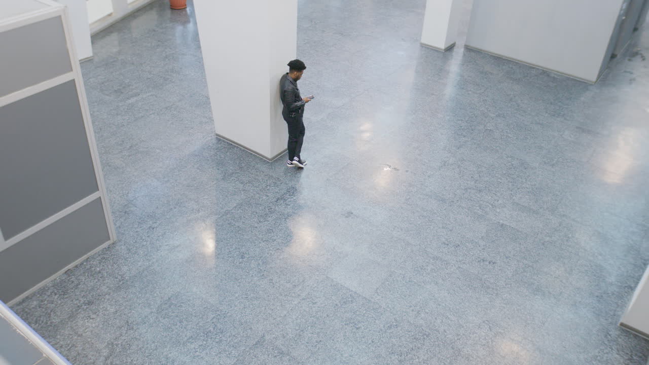 People interacting and using smartphones in a modern building lobby