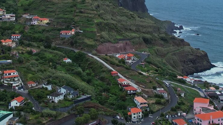 Stunning aerial view of coastal homes in Madeira, Portugal at sunset