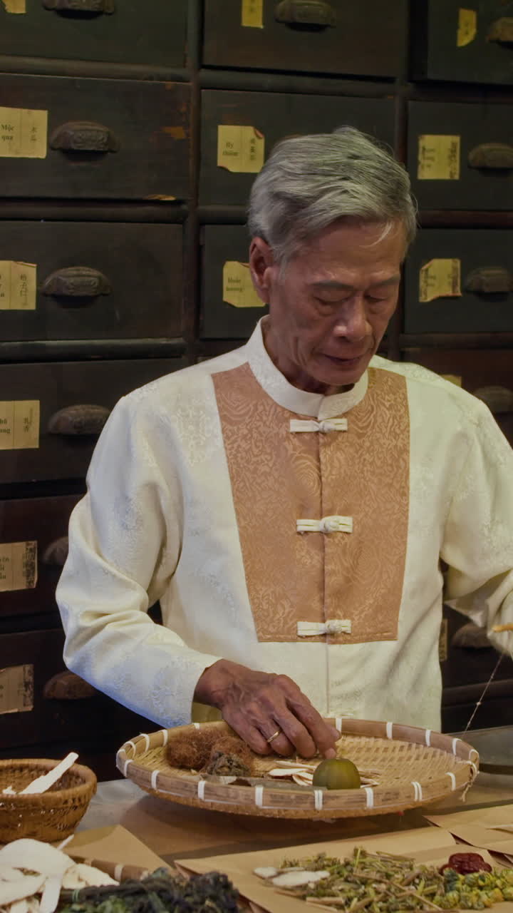 Alternative Medicine Apothecary Putting Dried Herbs on Scales