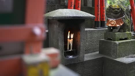 candles burning in slow motion at fushimi shrine, kyoto japan