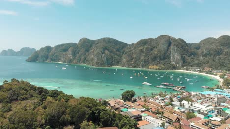 Reveal-of-Ton-Sai-Beach-encircled-by-enchanting-Ko-Phi-Phi-Don-Island-Landscape,-Thailand---Aerial-Fly-over-Reveal-shot