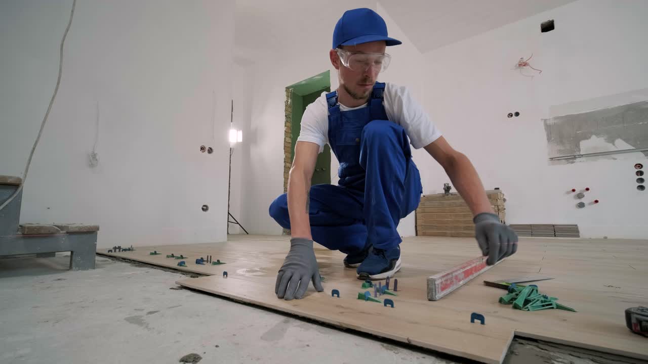 Construction, renovation, repair apartment. Installing ceramic floor tiles - measuring and cutting the pieces. Cuts tile. Tile cutting