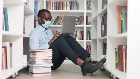 student working on laptop in library