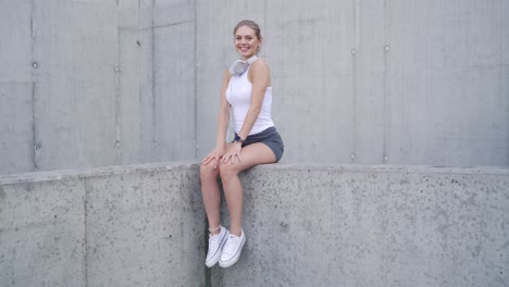 woman sitting on a concrete wall