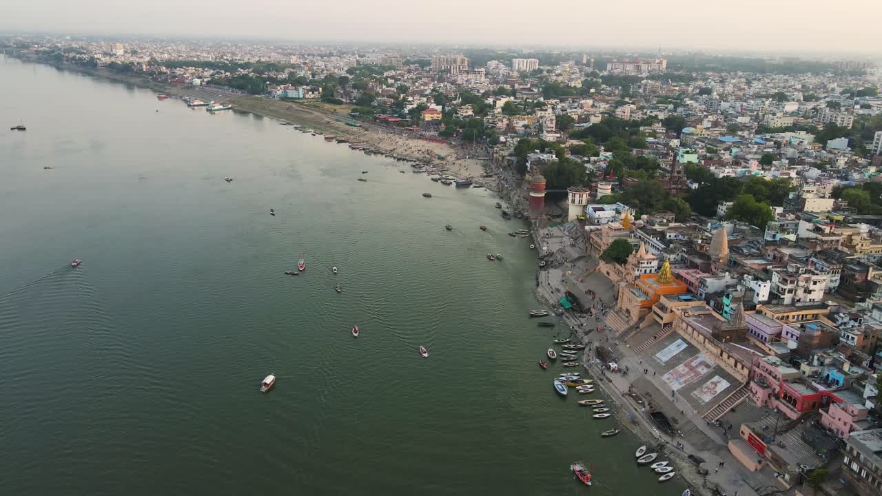 Drone shot of Banaras at sunset, with the Ganga River reflecting the rich colors of the evening sky.