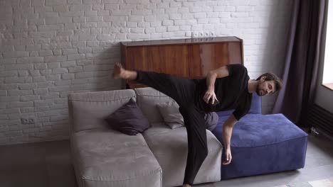 Man-in-slowmo-falling-on-a-couch-with-smartphone,-scrolling-various-gestures,-like-swiping-and-scrolling