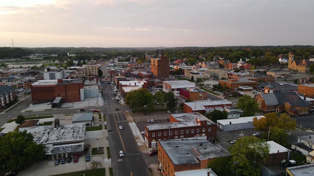 Aerial view of downtown Massillon, Ohio at sunset featuring historic buildings and streets. Orbit Right Sunset N