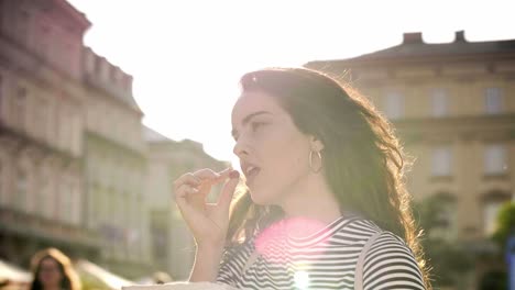 Girl-eating-raspberries-outdoors